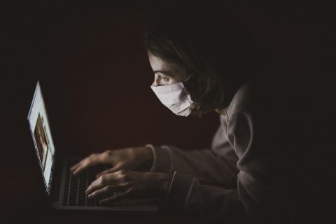 lady wearing face mask at laptop