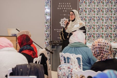 Rasha El-Haggan holding Mic at the ISLA Retreat in 2025